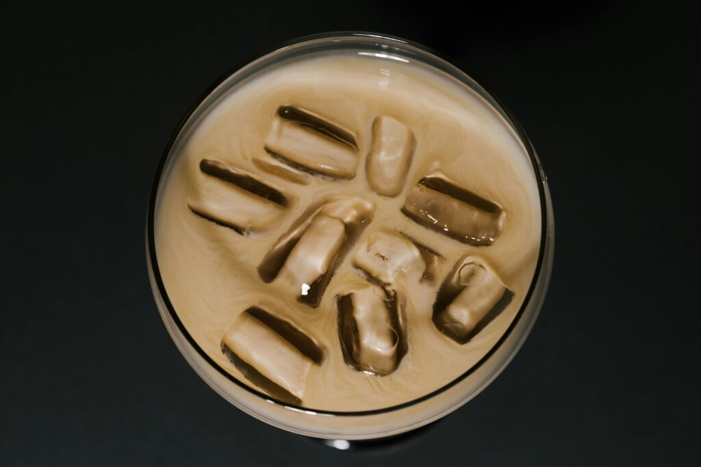 Refreshing iced coffee with visible ice cubes from above, showcasing chilled beverage.