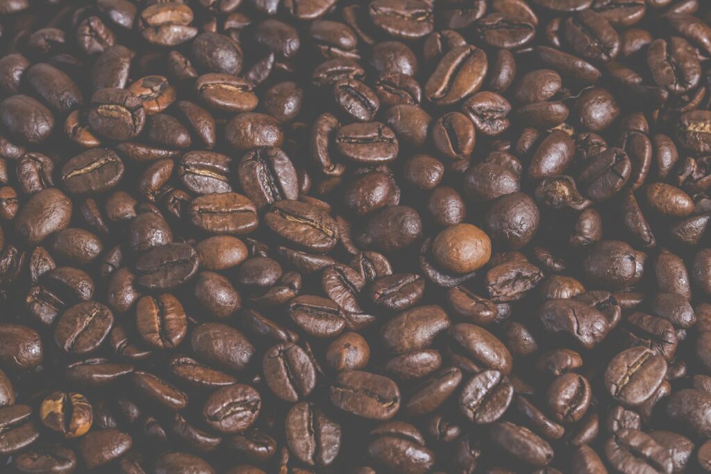 A detailed macro shot of aromatic roasted coffee beans showing texture and rich color.